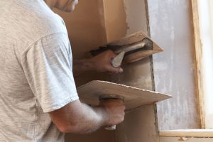 Plasterer Working On Interior Wall
