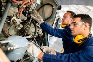 Mechanics fixing the engine of a helicopter